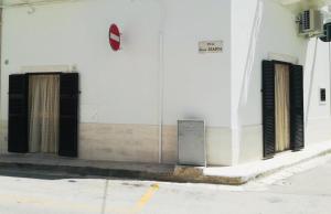 two doors on the side of a white building at La Casetta di Ninella in Polignano a Mare