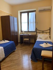 Posteľ alebo postele v izbe v ubytovaní LA TERRAZZA SUL CORSO City Center