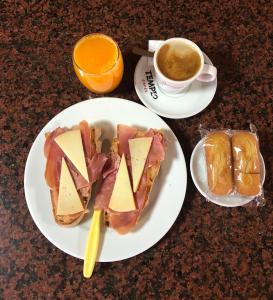 a plate of food with sandwiches and a cup of coffee at Hostal Restaurante Taibilla in Nerpio