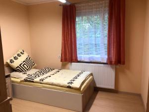 a small bedroom with a bed and a window at Holiday house EWA in Meszna Opacka +40 photos