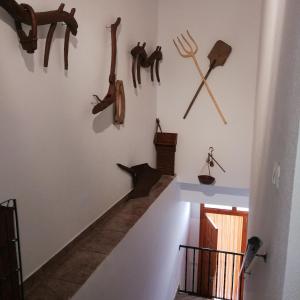 a hallway with some wooden items on the wall at Apartamentos Rurales Hermanos Alcalá in Ibdes