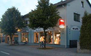 a store on a street with a tree in front of it at Apartment Wurth in Groß-Siegharts