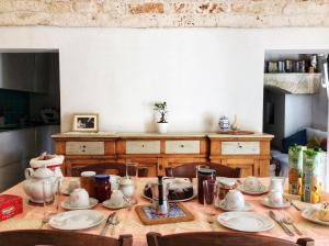 a table with plates and utensils on it at Casale Petrarolo in Monopoli