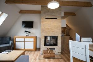 a living room with a fireplace and a couch at Prestige Apartamenty Smrekowa in Zakopane