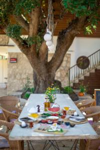 a table with food on it in front of a tree at Hotel Casa De Padre in Kemer
