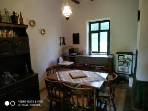 a dining room with a table and chairs at Darutollas Vendégház in Ópusztaszer
