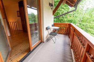 a balcony of a house with a table and a chair at Apartments Valant in Bled