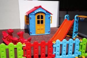 a childs play set with a plastic fence and a playground at Seren Sari Hotel in Marmaris