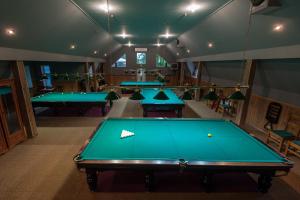 a room with four pool tables in it at Leoton Chernivtsi in Chernivtsi