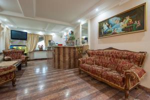 a living room with a couch and a painting on the wall at Leoton Chernivtsi in Chernivtsi