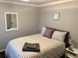 a small bedroom with a bed with a mirror at AB - Top floor 2 bed modern town centre apartment with parking for one vehicle in Stratford-upon-Avon