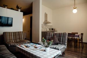 a living room with two couches and a table at Tbilisi Apartment in Tbilisi City