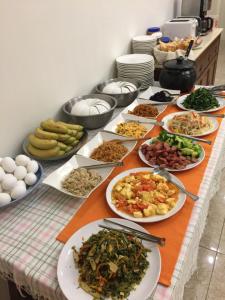 a table with many plates of food on it at He Sen B&B in Kenting