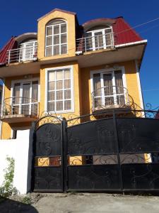 a house with a black gate in front of it at Home in Batumi +19 photos