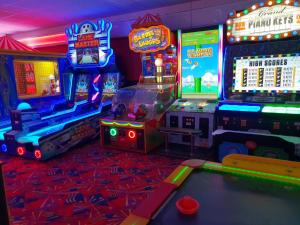 a room with arcade games and a pool table at Holiday Home in Lyons Robin Hood Holiday Park in Meliden