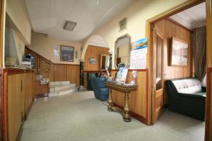 a hallway with chairs and a table in a room at Hostal La Perla Asturiana in Madrid