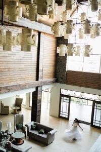 a woman in a wedding dress walking in a living room at Sola Hotel in Laoag