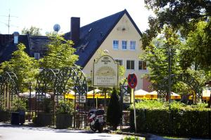a white building with a sign in front of it at Langwieder See in Munich