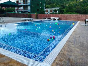 a swimming pool with balls in the water at Guesthouse Gio in Gonio