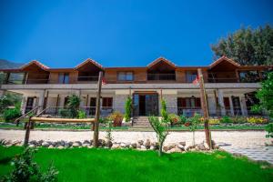 a large house with a green lawn in front of it at Hotel Casa De Padre in Kemer