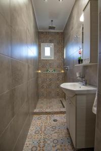 a bathroom with a sink and a shower at Haraki Villas in Haraki