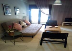 a living room with a couch and a table at Karditsa Home Sweet Home 80 τ.μ in Kardítsa