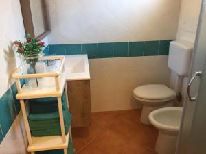 a bathroom with a toilet and a sink at CASA BIJOUX in Olbia +16 photos