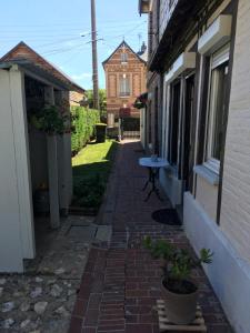 een stenen loopbrug tussen twee gebouwen met een huis bij CHAMBRE La Petite VENISE in Pont-Audemer