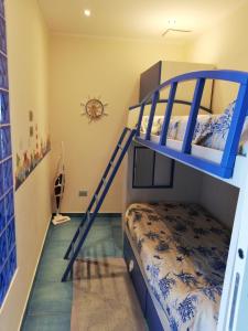 a bedroom with a bunk bed with a blue bunk ladder at Appartamento Valeria e Andrea in Porto Santo Stefano