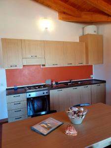 a kitchen with a table with a bowl of food on it at Residence Ataras in Porto San Paolo