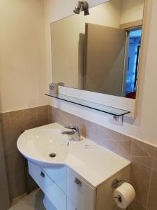 a bathroom with a sink and a mirror at Appartamento Betty in Porto Santo Stefano