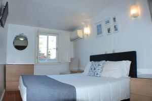 a bedroom with a large bed and a window at Dear Porto Guest House in Porto