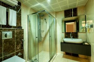 a bathroom with a shower and a sink at A Palace Suites in Istanbul