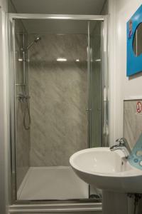 a bathroom with a shower and a sink at The cabin saracens head in Chapel Saint Leonards