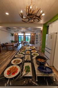 una mesa larga con muchos platos de comida. en Rambling Snail, en Luodong