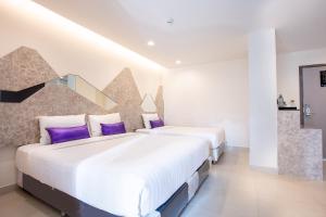 Katil atau katil-katil dalam bilik di Spittze Hotel Pratunam