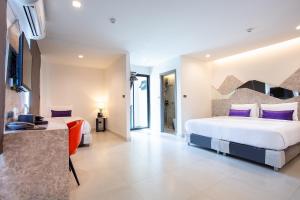 Katil atau katil-katil dalam bilik di Spittze Hotel Pratunam