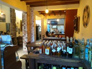a bar with a bunch of bottles of alcohol at Cafe Preto Pousada e Bistrô in Mucugê