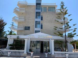 a hotel in front of a tall building at Hotel Dodona in Sarandë