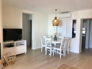 a kitchen and dining room with a table and chairs at São Rafael Beach Apartment in Albufeira