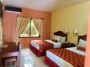 Postel nebo postele na pokoji v ubytování Hotel Plaza Maria