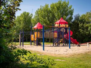 a playground in a park with a slide at Luxe Lodge Zeehoeve in Harlingen