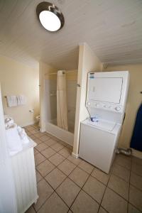 a bathroom with a washer and dryer in a room at DeSoto Beach Terraces in Tybee Island +22 photos