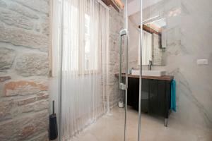 a bathroom with a glass shower and a sink at Apartments Sea View - Sunrise and Maremonte in Rovinj +45 photos