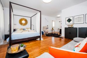 a bedroom with a bed with a large mirror at Apartments Sea View - Sunrise and Maremonte in Rovinj