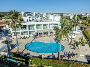 an overhead view of a swimming pool in front of a building at Bellini Hotel in Ayia Napa