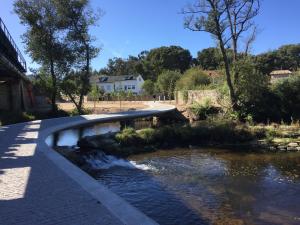 a bridge over a river with a small stream at Beach and Mountain Paradise in Vila Praia de Âncora