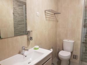 a bathroom with a white toilet and a sink at Beach and Mountain Paradise in Vila Praia de Âncora +34 photos