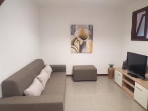 a living room with a couch and a tv at Beach and Mountain Paradise in Vila Praia de Âncora