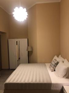 a bedroom with a large bed and a light at PARADISE INN in Livorno
